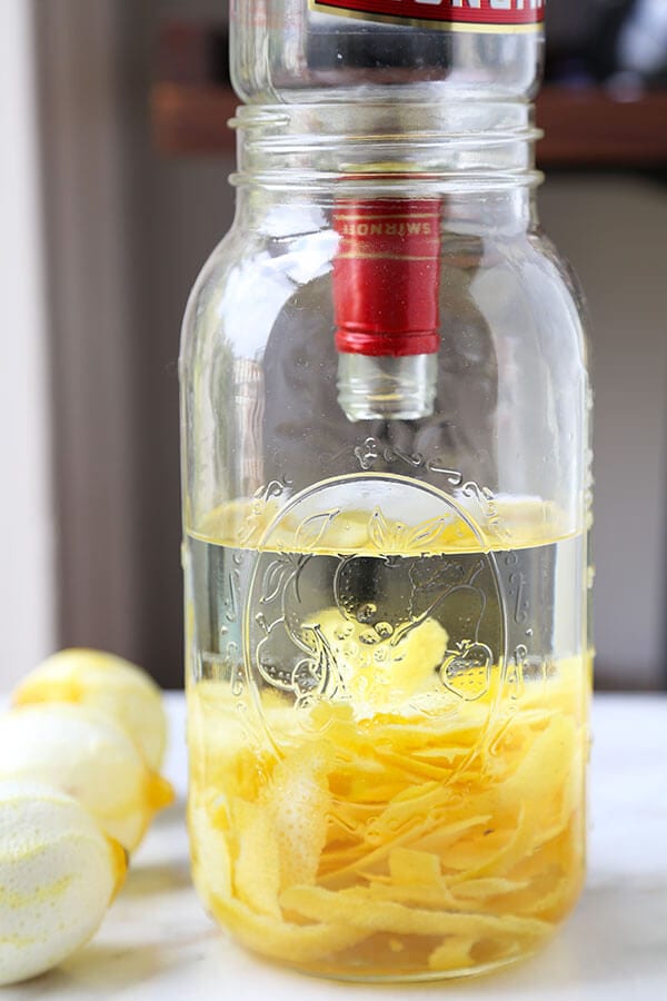 Limoncello - Make your own Limoncello this holiday season with just 3 ingredients! Serve it with soda and a splash of cranberry juice or bottle it up for the cutest and cheeriest homemade gift! Recipe, how to make limoncello, diy, alcohol, cocktail, vodka, drink | pickledplum.com