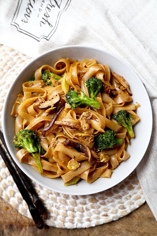 Veggie Pad See Ew - Chew on these savory Thai rice noodles in less than 16 minutes! This a traditional Pad See Ew recipe made with all broccoli and mushrooms and sprinkled with plenty of chili powder. Recipe, Thai food, Asian noodles, stir fry, vegetables | pickledplum.com