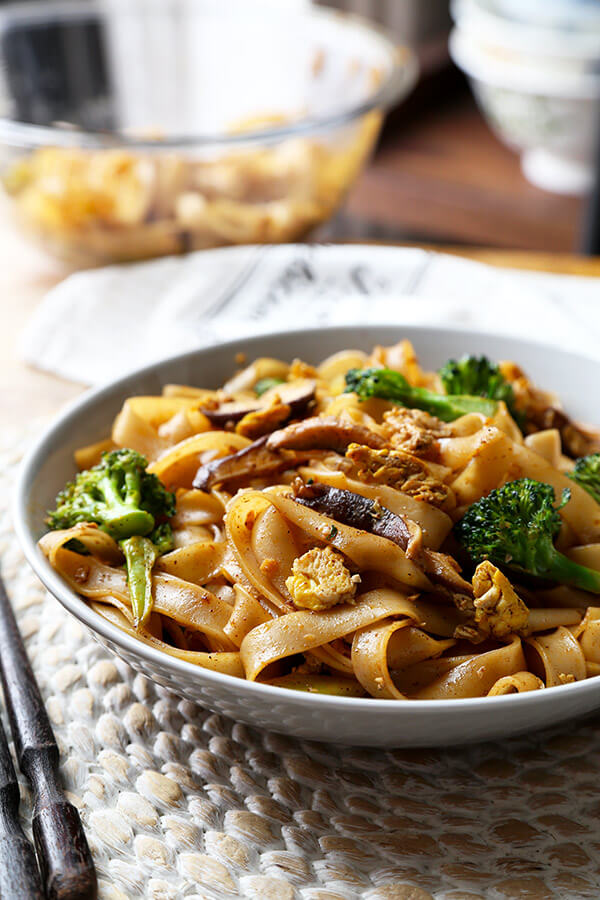 Veggie Pad See Ew - Chew on these savory Thai rice noodles in less than 16 minutes! This a traditional Pad See Ew recipe made with all broccoli and mushrooms and sprinkled with plenty of chili powder. Recipe, Thai food, Asian noodles, stir fry, vegetables | pickledplum.com