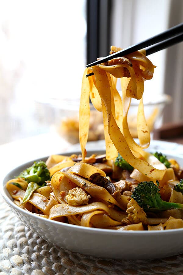 Veggie Pad See Ew - Chew on these savory Thai rice noodles in less than 16 minutes! This a traditional Pad See Ew recipe made with all broccoli and mushrooms and sprinkled with plenty of chili powder. Recipe, Thai food, Asian noodles, stir fry, vegetables | pickledplum.com