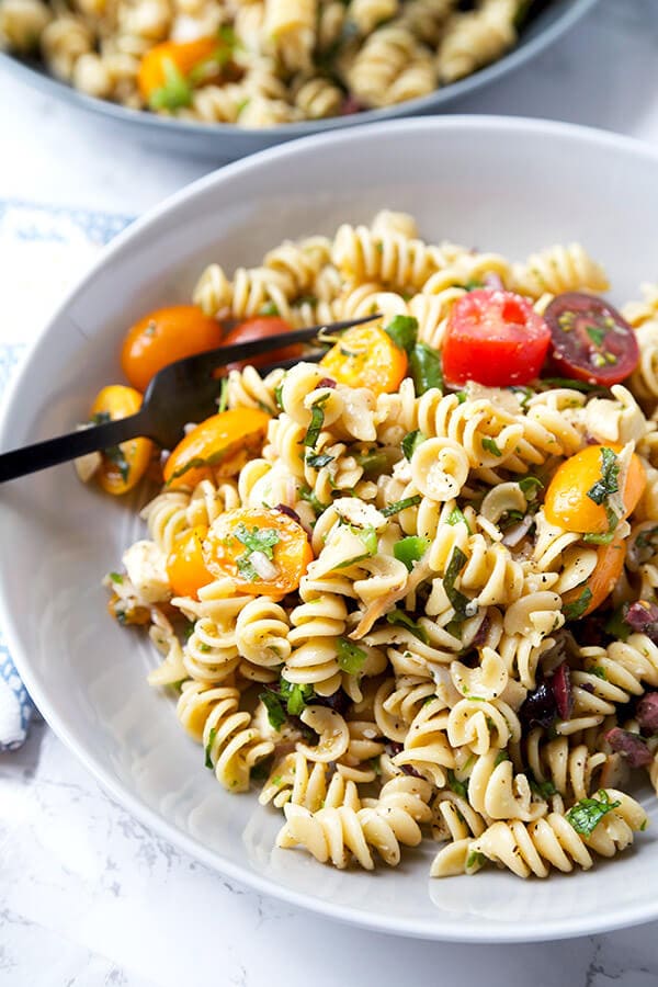 Italian Pasta Salad - Serve this bright, sweet and tangy Italian pasta salad at your next barbecue. It's the perfect summer salad filled with veggies, black olives, turkey and cheese, with a homemade Italian dressing so delicious you'll want to use it on everything! Recipe, salad, healthy pasta salad, tomato salad | pickledplum.com