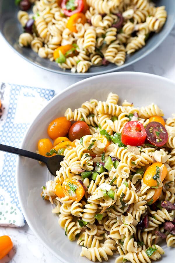 Italian Pasta Salad - Serve this bright, sweet and tangy Italian pasta salad at your next barbecue. It's the perfect summer salad filled with veggies, black olives, turkey and cheese, with a homemade Italian dressing so delicious you'll want to use it on everything! Recipe, salad, healthy pasta salad, tomato salad | pickledplum.com