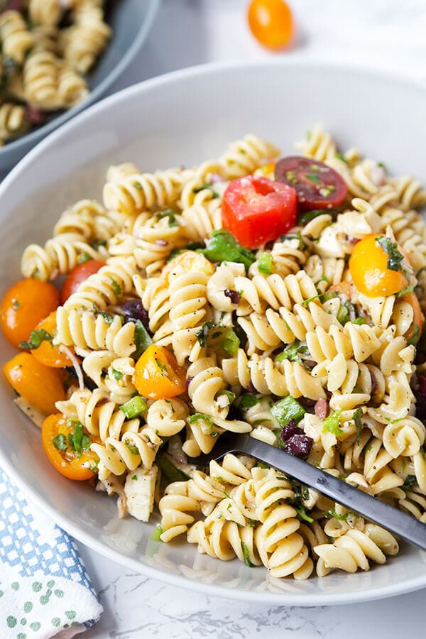 Italian Pasta Salad - Serve this bright, sweet and tangy Italian pasta salad at your next barbecue. It's the perfect summer salad filled with veggies, black olives, turkey and cheese, with a homemade Italian dressing so delicious you'll want to use it on everything! Recipe, salad, healthy pasta salad, tomato salad | pickledplum.com