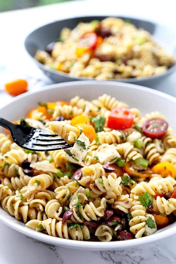 Italian Pasta Salad - Serve this bright, sweet and tangy Italian pasta salad at your next barbecue. It's the perfect summer salad filled with veggies, black olives, turkey and cheese, with a homemade Italian dressing so delicious you'll want to use it on everything! Recipe, salad, healthy pasta salad, tomato salad | pickledplum.com