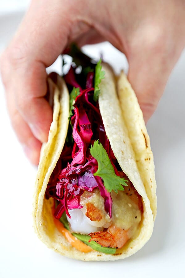 Shrimp Tacos with Tomatillo Sauce - Who knew it was this easy to make unforgettable shrimp tacos topped with colorful, refreshing and tasty toppings! Not only are these tacos healthy, they are addictive! Recipe, Mexican, tacos, seafood, healthy | pickledplum.com