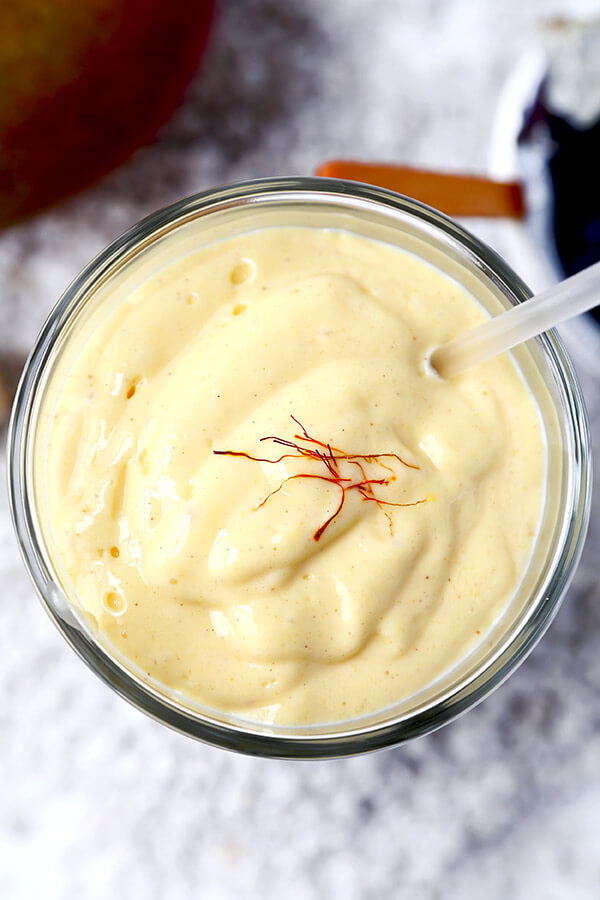 Mango Lassi - Drink it for breakfast, as a mid afternoon snack or serve it for dessert! This 5-ingredients only Mango Lassi recipe is sweet, nutritious and beyond refreshing on a hot summer day! Indian recipe, healthy smoothie recipe, yogurt drink, fruit shake | @oikos, @dannon | pickledplum.com 