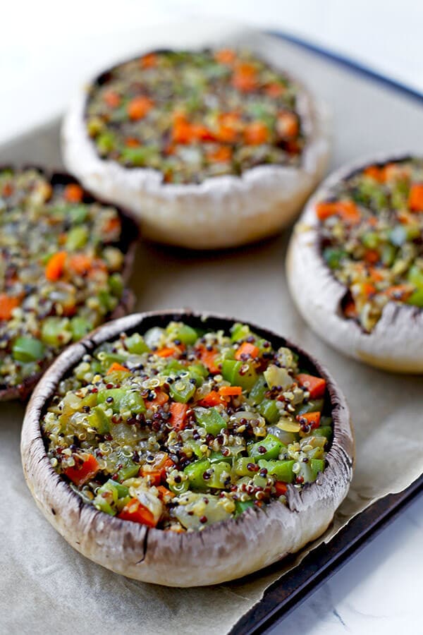 Stuffed Mushrooms with Soy and Sesame Sauce - Lighten up dinner time with these easy and delicious mushrooms stuffed with a blend of quinoa and vegetables and topped with crunchy scallions and melted cheese. Ready in 30 minutes! vegan recipe, vegan stuffed mushrooms, vegetarian dinner, vegan quinoa dinner, healthy vegetarian food | pickledplum.com