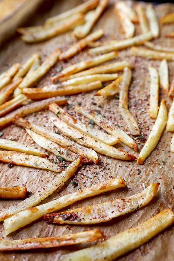 Oven Baked Za'atar Fries - These are the best oven baked fries you've ever tasted! Tossed in a homemade za'atar spice mix, they are salty, lemony, peppery and loaded with fresh herbs - plus, they are healthy too! healthy french fries recipe, healthy potato recipe, homemade za'atar seasoning, healthy snack, healthy vegan snack | pickledplum.com 