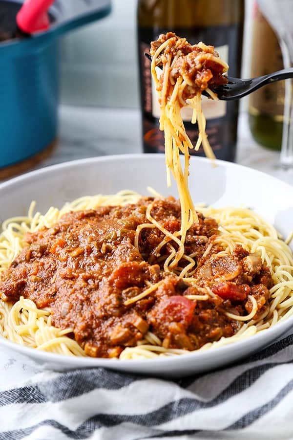 Vegan Spaghetti Bolognese - This vegan bolognese sauce is made with mushrooms to give it a meaty texture. This makes an excellent family recipe since your kids won't be able to tell the difference! You can also you a crockpot or slow cooker to make this yummy vegan spaghetti sauce #veganrecipes #veganfood #veganlife #plantbased #plantbaseddiet | pickledplum.com