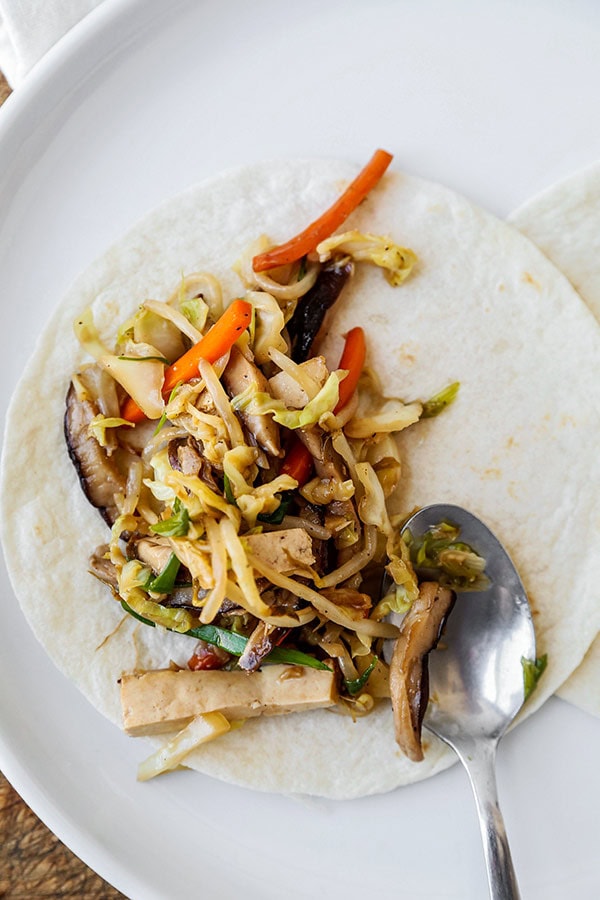 Recette de tofu moo shu - Ce post est un tofu moo shu végétarien sain, rempli de légumes et mélangé à une sauce sucrée et salée. Vous pouvez utiliser des tortillas ou des feuilles de laitue pour faire office de crêpe pour ce sauté rapide. De la nourriture chinoise faite maison, plus saine et prête en seulement 20 minutes ! #chinesefood #stirfry #healthyeating #vegetables #tofu | pickledplum.com