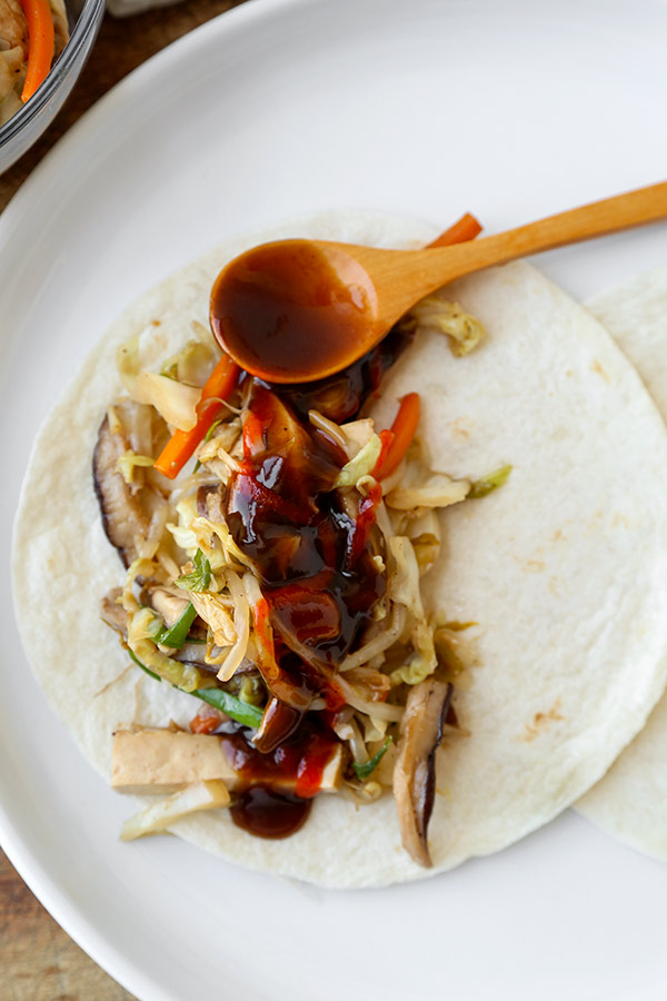 Mu Shoo Tofu Recipe - This post is a healthy vegetarian moo shu tofu, packed with vegetables and tossed in a sweet and savory sauce. You can use tortillas or lettuce wraps to act as a pancake for this quick stir fry. Homemade Chinese Food made healthier and ready in just 20 minutes! #chinesefood #stirfry #healthyeating #vegetables #tofu | pickledplum.com