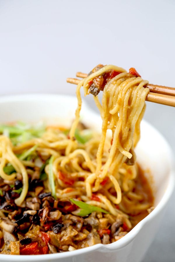 Vegan tantanmen recipe - Ditch the pork and make yourself and healthier bowl of tantanmen today! Earthy mushrooms and sweet red bell peppers dance in a spicy, savory and nutty broth packed with umami. This is one dish you will want to add to your meatless meal rotation! Ready in 25 minutes from start to finish. #ramen #recipes #vegan #vegetarian | pickledplum.com