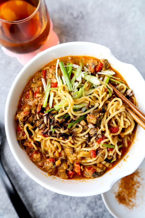 Vegan tantanmen recipe - Ditch the pork and make yourself and healthier bowl of tantanmen today! Earthy mushrooms and sweet red bell peppers dance in a spicy, savory and nutty broth packed with umami. This is one dish you will want to add to your meatless meal rotation! Ready in 25 minutes from start to finish. #ramen #recipes #vegan #vegetarian | pickledplum.com