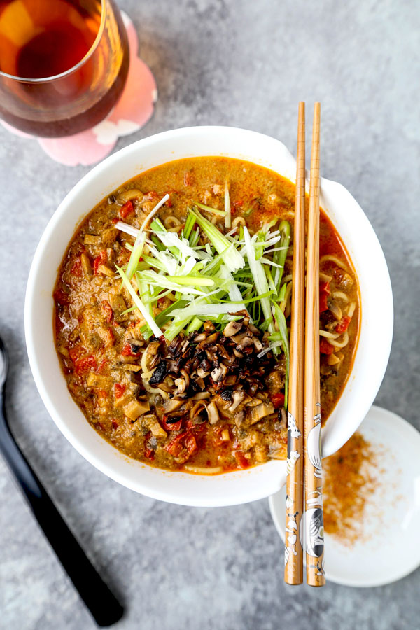 Vegan tantanmen recipe - Ditch the pork and make yourself and healthier bowl of tantanmen today! Earthy mushrooms and sweet red bell peppers dance in a spicy, savory and nutty broth packed with umami. This is one dish you will want to add to your meatless meal rotation! Ready in 25 minutes from start to finish. #ramen #recipes #vegan #vegetarian | pickledplum.com