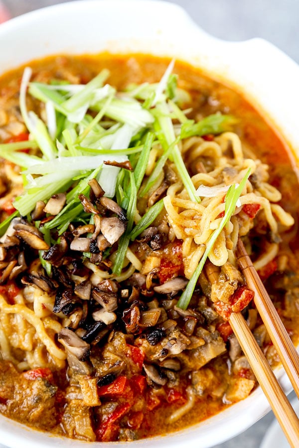 Vegan tantanmen recipe - Ditch the pork and make yourself and healthier bowl of tantanmen today! Earthy mushrooms and sweet red bell peppers dance in a spicy, savory and nutty broth packed with umami. This is one dish you will want to add to your meatless meal rotation! Ready in 25 minutes from start to finish. #ramen #recipes #vegan #vegetarian | pickledplum.com