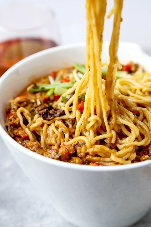 Vegan tantanmen recipe - Ditch the pork and make yourself and healthier bowl of tantanmen today! Earthy mushrooms and sweet red bell peppers dance in a spicy, savory and nutty broth packed with umami. This is one dish you will want to add to your meatless meal rotation! Ready in 25 minutes from start to finish. #ramen #recipes #vegan #vegetarian | pickledplum.com