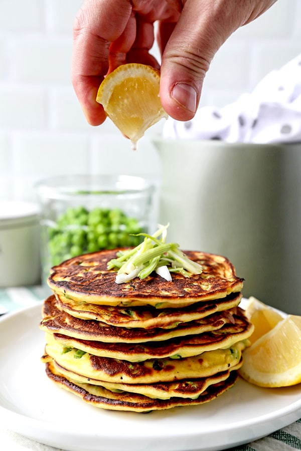 Spring Pea Pancakes - A bright and pillowy soft Spring Pea Pancakes Recipe. These small savory pancakes have the verdant pop of fresh green peas. Find out how to choose the best fresh peas - and info on frozen vs fresh spring peas. It’s springtime on a plate! #pancakes #healthyeating #brunch #peas | pickledplum.com