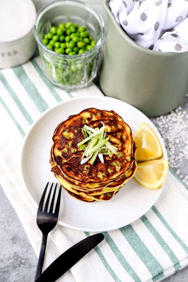 Spring Pea Pancakes - A bright and pillowy soft Spring Pea Pancakes Recipe. These small savory pancakes have the verdant pop of fresh green peas. Find out how to choose the best fresh peas - and info on frozen vs fresh spring peas. It’s springtime on a plate! #pancakes #healthyeating #brunch #peas | pickledplum.com