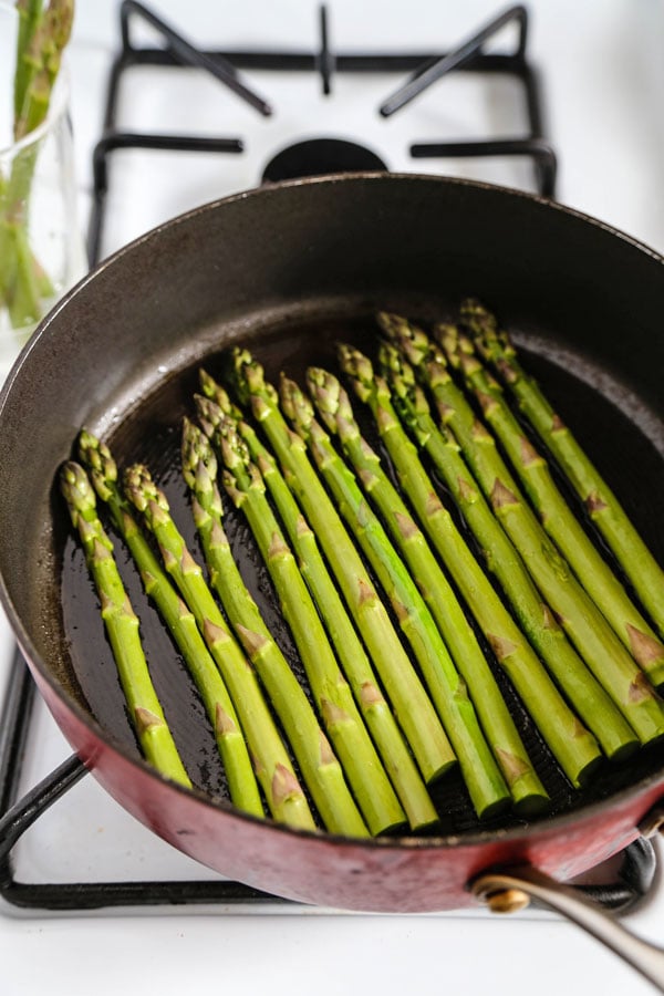 sauteeing asparagus in the pan