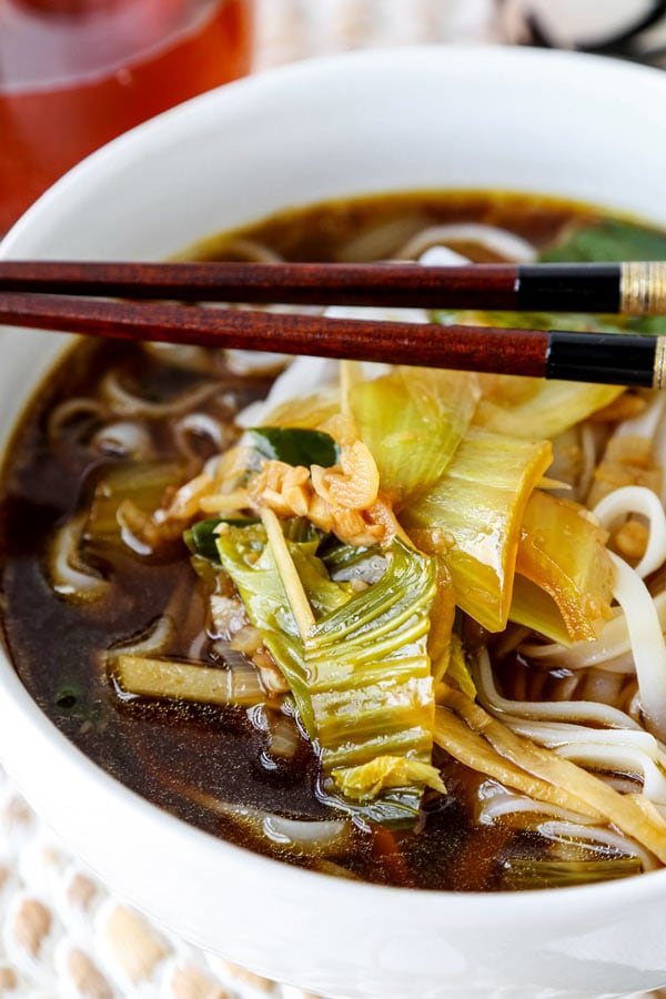 Baby bok choy soup with garlic and ginger - This hot and savory Baby Bok Choy Soup With Garlic and Ginger is summer eating at its best. Loaded with rice noodles, this fragrant Asian soup recipe is easy to make and packed with deep, umami flavor. #souprecipe #healthyeating #noodlesoup #ginger | pickledplum.com