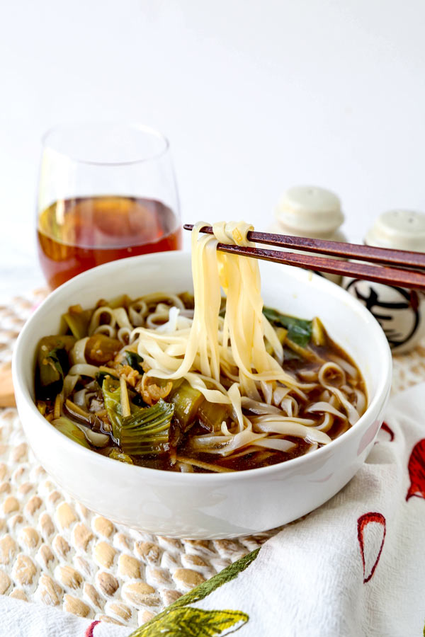 Baby bok choy soup with garlic and ginger - This hot and savory Baby Bok Choy Soup With Garlic and Ginger is summer eating at its best. Loaded with rice noodles, this fragrant Asian soup recipe is easy to make and packed with deep, umami flavor. #souprecipe #healthyeating #noodlesoup #ginger | pickledplum.com