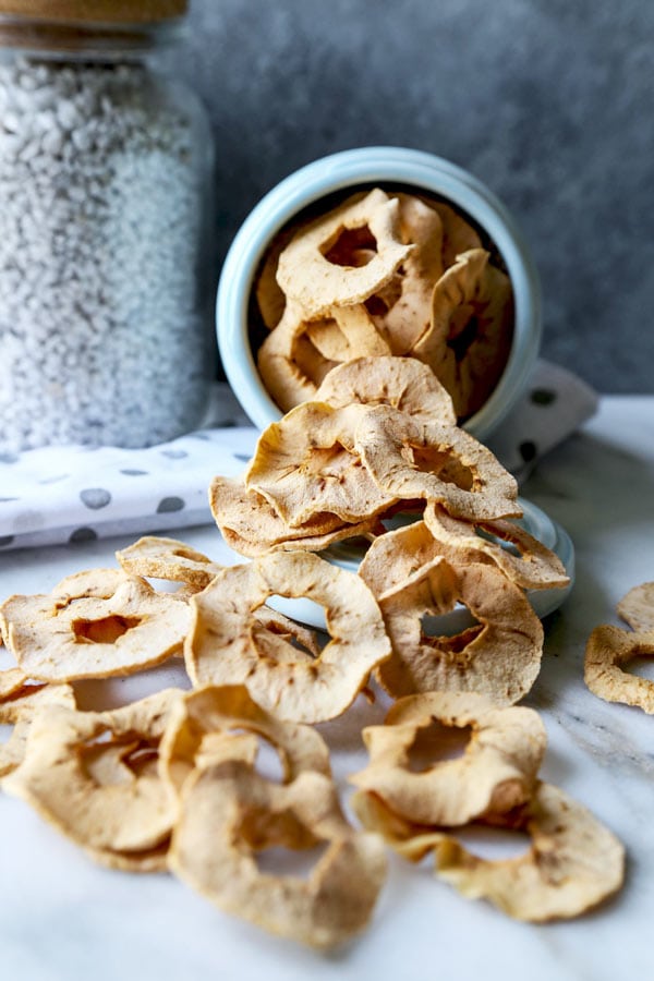 Homemade Baked Apple Chips - Learn how to make easy, crispy baked apple chips in an oven (no dehydrator needed!) This is a healthy snack for kids and for weight loss. 100% natural, no sugar added. #veganrecipe #applerecipe #healthysnack #vegetarian #plantbased #kidfriendly #healthybaking | pickledplum.com 