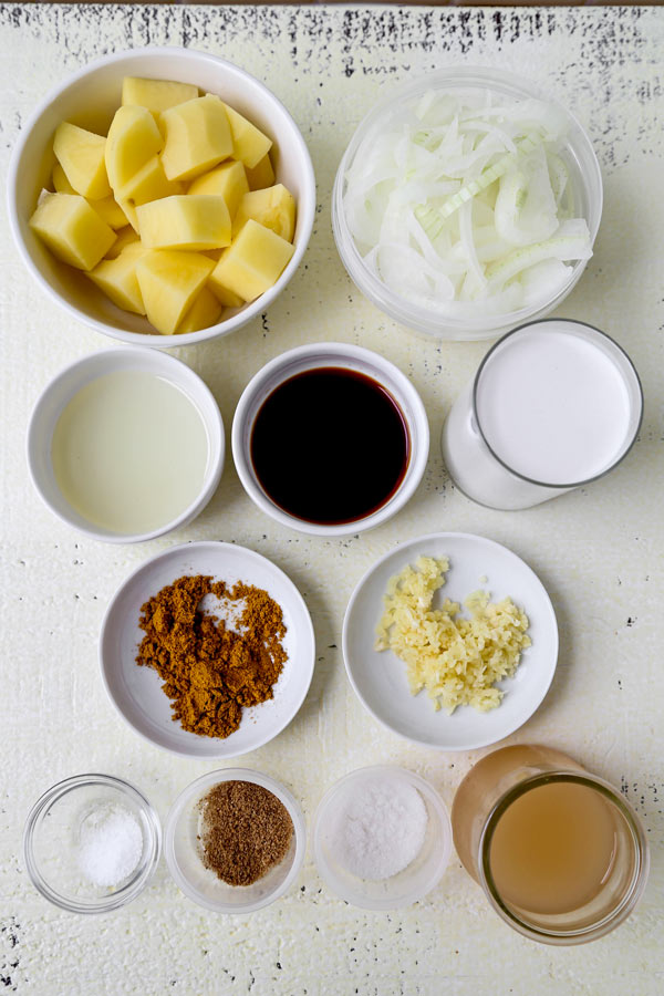 Thai Potato Curry (Vegan Recipe) - This is a quick and easy vegetarian curry loaded with potatoes and onions. It's an authentic Thai curry that's healthy and simple and only takes 30 minutes to make (from scratch). Yellow curry powder, soy sauce and coconut milk are the base of this vegan curry. Comforting, savory, delicious! #curryrecipes #healthyeating #thaifood #veganrecipes #vegetarianrecipes | pickledplum.com