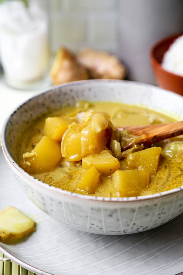 Thai Potato Curry (Vegan Recipe) - This is a quick and easy vegetarian curry loaded with potatoes and onions. It's an authentic Thai curry that's healthy and simple and only takes 30 minutes to make (from scratch). Yellow curry powder, soy sauce and coconut milk are the base of this vegan curry. Comforting, savory, delicious! #curryrecipes #healthyeating #thaifood #veganrecipes #vegetarianrecipes | pickledplum.com