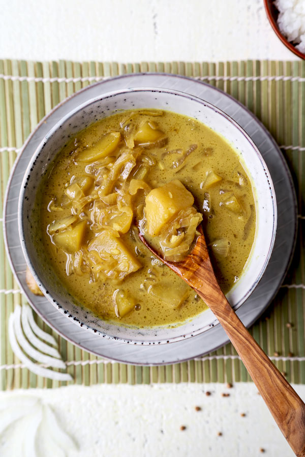 Thai Potato Curry (Vegan Recipe) - This is a quick and easy vegetarian curry loaded with potatoes and onions. It's an authentic Thai curry that's healthy and simple and only takes 30 minutes to make (from scratch). Yellow curry powder, soy sauce and coconut milk are the base of this vegan curry. Comforting, savory, delicious! #curryrecipes #healthyeating #thaifood #veganrecipes #vegetarianrecipes | pickledplum.com