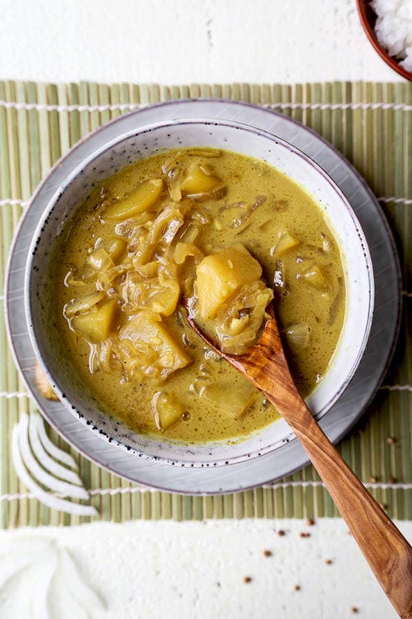 Thai Potato Curry (Vegan Recipe) - This is a quick and easy vegetarian curry loaded with potatoes and onions. It's an authentic Thai curry that's healthy and simple and only takes 30 minutes to make (from scratch). Yellow curry powder, soy sauce and coconut milk are the base of this vegan curry. Comforting, savory, delicious! #curryrecipes #healthyeating #thaifood #veganrecipes #vegetarianrecipes | pickledplum.com