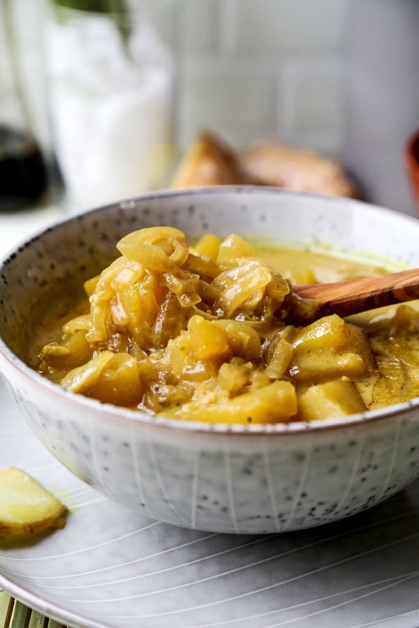 Thai Potato Curry (Vegan Recipe) - This is a quick and easy vegetarian curry loaded with potatoes and onions. It's an authentic Thai curry that's healthy and simple and only takes 30 minutes to make (from scratch). Yellow curry powder, soy sauce and coconut milk are the base of this vegan curry. Comforting, savory, delicious! #curryrecipes #healthyeating #thaifood #veganrecipes #vegetarianrecipes | pickledplum.com