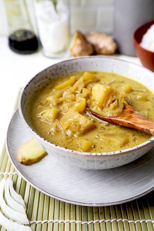 Thai Potato Curry (Vegan Recipe) - This is a quick and easy vegetarian curry loaded with potatoes and onions. It's an authentic Thai curry that's healthy and simple and only takes 30 minutes to make (from scratch). Yellow curry powder, soy sauce and coconut milk are the base of this vegan curry. Comforting, savory, delicious! #curryrecipes #healthyeating #thaifood #veganrecipes #vegetarianrecipes | pickledplum.com