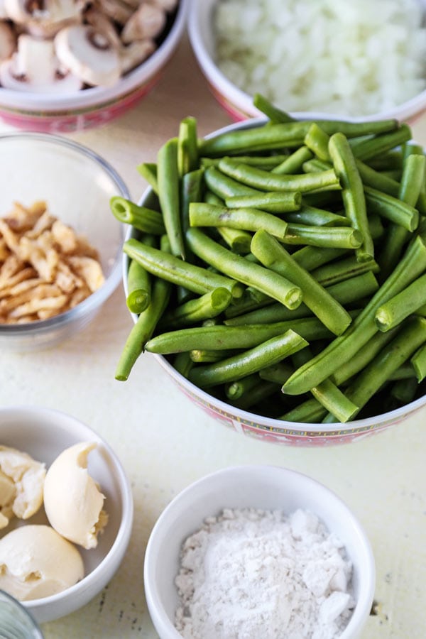 Slow Cooker Green Bean Casserole (Vegan) - A healthy holiday dinner recipe (or Thanksgiving side) that will make you fall in love with plant based foods. Mushrooms, onions and green beans slow cooked in a creamy, cheesy sauce made with nutritional yeast, flour and unsweetened almond milk. #veganrecipes #plantbased #vegetarianrecipes #thanksgivingrecipe | pickledplum.com