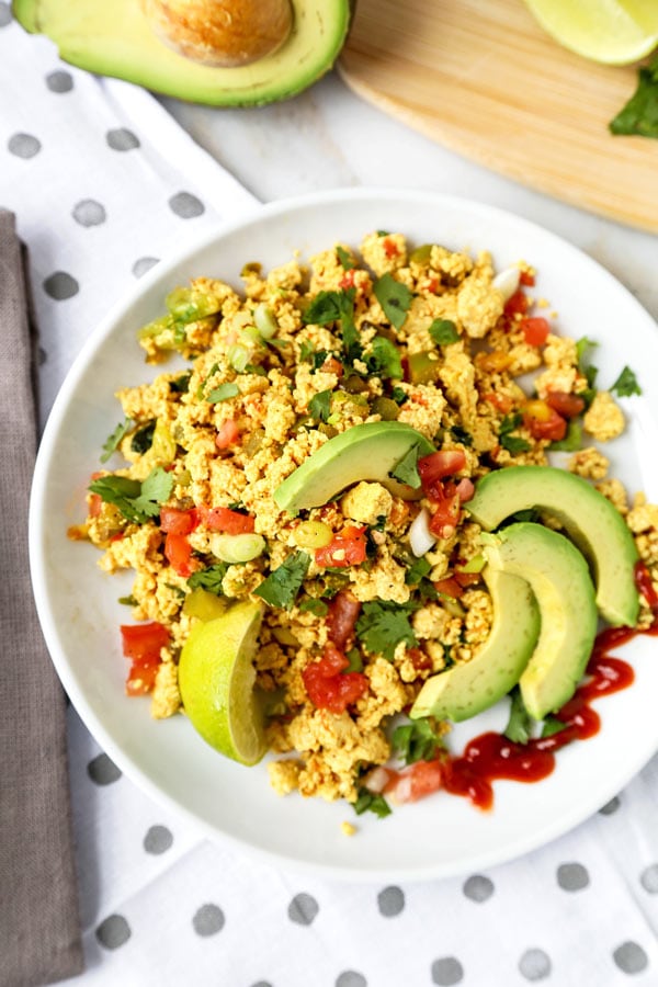 Mexican Style Tofu Scramble - An easy and delicious vegan breakfast recipe you can serve for dinner too! This Mexican Style Tofu Scramble Recipe could easily pass for a hearty plate of Huevos Rancheros! No turmeric used, we are going for Tex Mex flavors! #tofurecipes #tofuscramble #veganrecipes #veganbreakfast #meatlessmonday | pickledplum.com