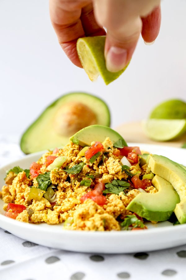 Mexican Style Tofu Scramble - An easy and delicious vegan breakfast recipe you can serve for dinner too! This Mexican Style Tofu Scramble Recipe could easily pass for a hearty plate of Huevos Rancheros! No turmeric used, we are going for Tex Mex flavors! #tofurecipes #tofuscramble #veganrecipes #veganbreakfast #meatlessmonday | pickledplum.com