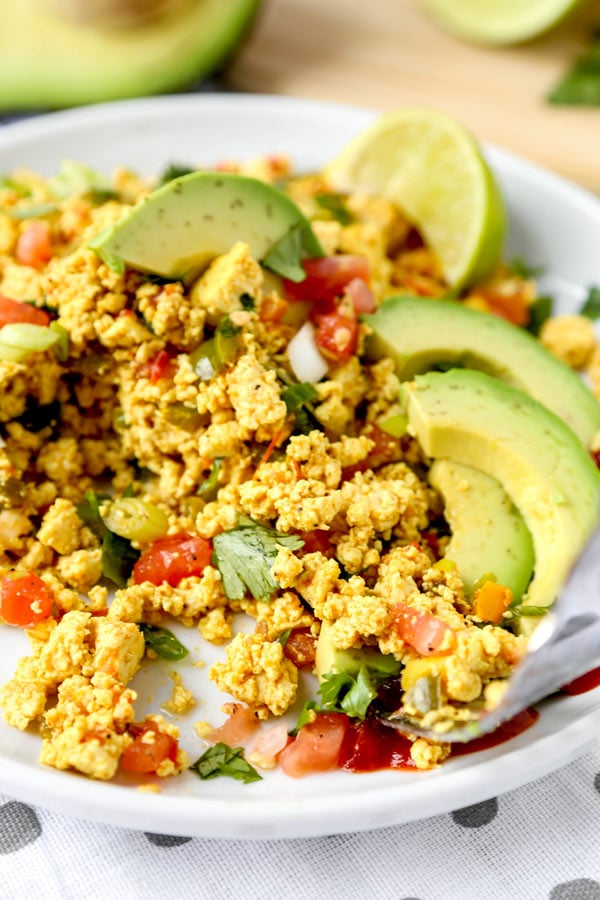 Mexican Style Tofu Scramble - An easy and delicious vegan breakfast recipe you can serve for dinner too! This Mexican Style Tofu Scramble Recipe could easily pass for a hearty plate of Huevos Rancheros! No turmeric used, we are going for Tex Mex flavors! #tofurecipes #tofuscramble #veganrecipes #veganbreakfast #meatlessmonday | pickledplum.com