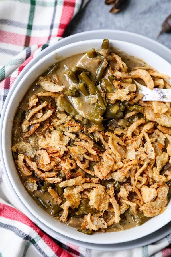 Slow Cooker Green Bean Casserole (Vegan) - A healthy holiday dinner recipe (or Thanksgiving side) that will make you fall in love with plant based foods. Mushrooms, onions and green beans slow cooked in a creamy, cheesy sauce made with nutritional yeast, flour and unsweetened almond milk. #veganrecipes #plantbased #vegetarianrecipes #thanksgivingrecipe | pickledplum.com