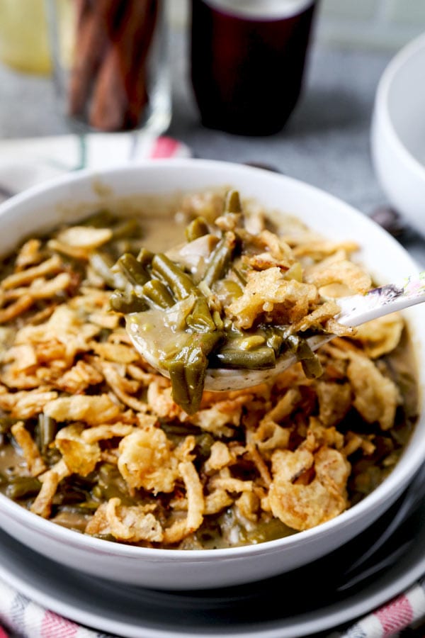 Slow Cooker Green Bean Casserole (Vegan) - A healthy holiday dinner recipe (or Thanksgiving side) that will make you fall in love with plant based foods. Mushrooms, onions and green beans slow cooked in a creamy, cheesy sauce made with nutritional yeast, flour and unsweetened almond milk. #veganrecipes #plantbased #vegetarianrecipes #thanksgivingrecipe | pickledplum.com