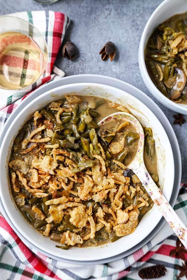 Slow Cooker Green Bean Casserole (Vegan) - A healthy holiday dinner recipe (or Thanksgiving side) that will make you fall in love with plant based foods. Mushrooms, onions and green beans slow cooked in a creamy, cheesy sauce made with nutritional yeast, flour and unsweetened almond milk. #veganrecipes #plantbased #vegetarianrecipes #thanksgivingrecipe | pickledplum.com