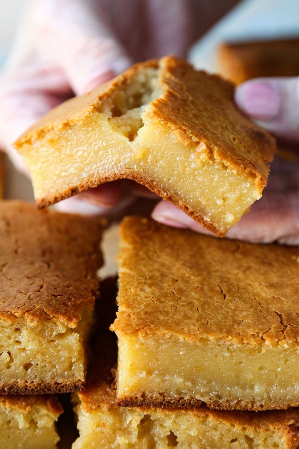 Healthier Hawaiian Butter Mochi Recipe - Hawaiian butter mochi is a sweet, chewy and stretchy dessert that's impossible to resist! I've substituted the butter for olive oil and some of the sugar for honey to add a floral note to this classic Hawaiian recipe.  #dessertrecipes #snacks #sweets | pickledplum.com