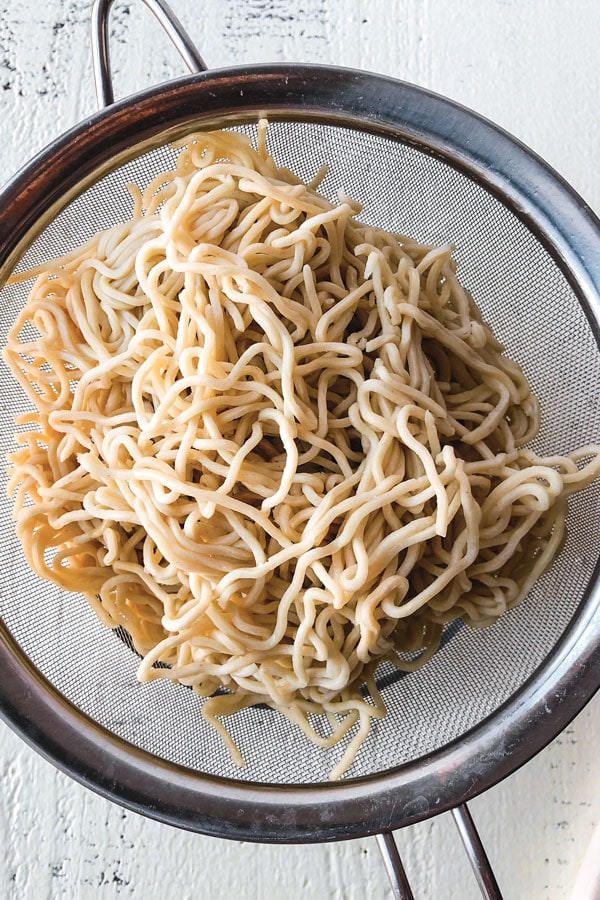 Shrimp lo mein is an easy Chinese recipe anyone can make at home! Use cabbage and your favorite veggies and stir fry them with egg noodles and an authentic lo mein sauce. Delicious! #pfchangs #stirfry #shrimprecipe #chinesefood | pickledplum.com