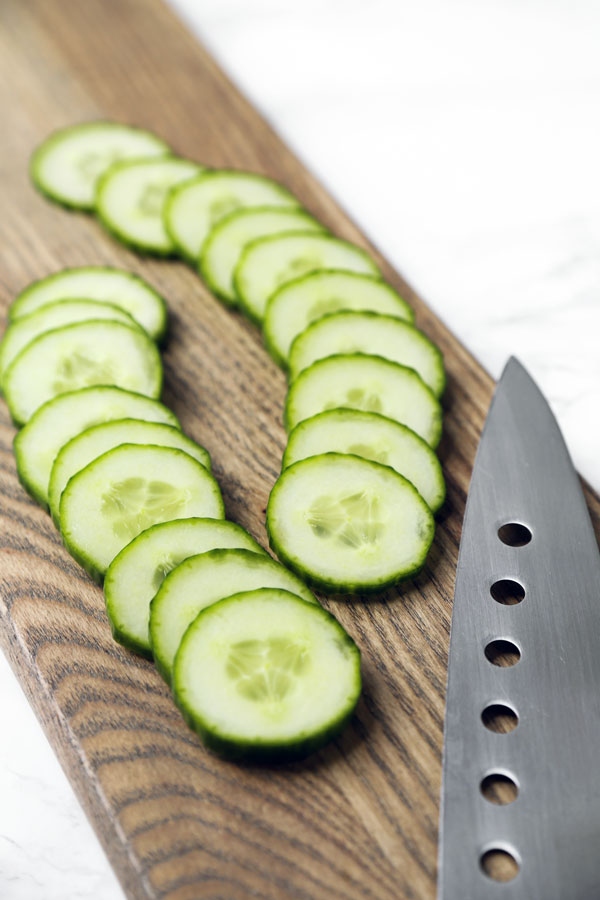 Sliced cucumbers on cutting board