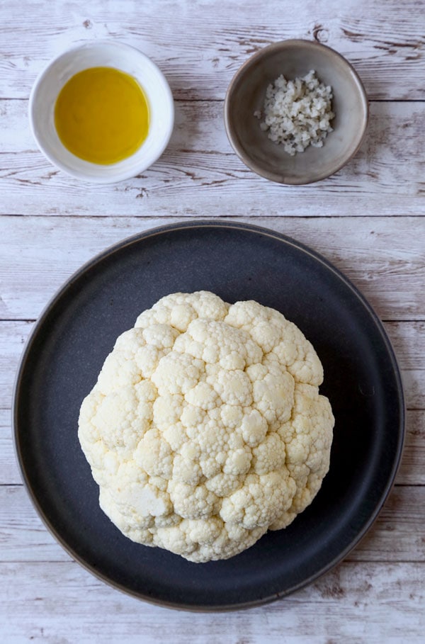 Whole Roasted Cauliflower Head - My favorite cauliflower recipe of all time! With only 3 ingredients needed and 5 minutes of prepping, little effort is required to making this dish - and it always gets the seal of approval! #veganrecipe #vegetarianrecipes #glutenfreerecipes #veggies #bakedcauliflower #keto | pickledplum.com