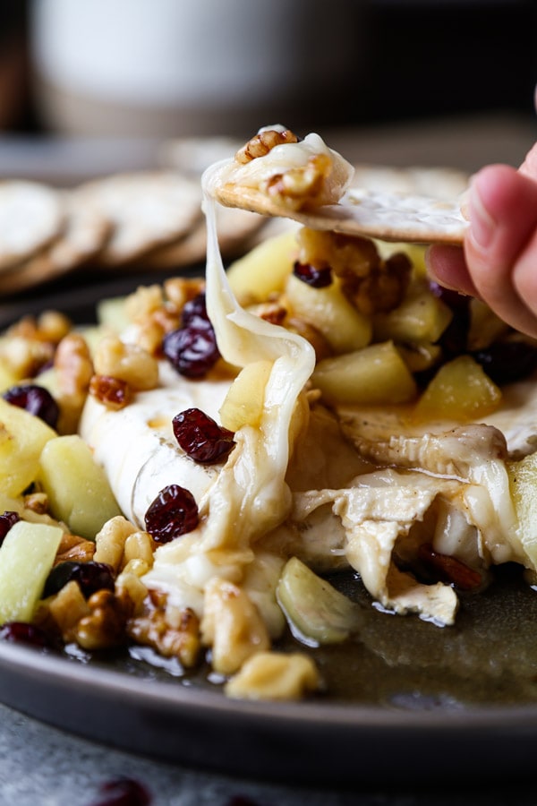 Baked brie with apples, dried cranberries and walnuts