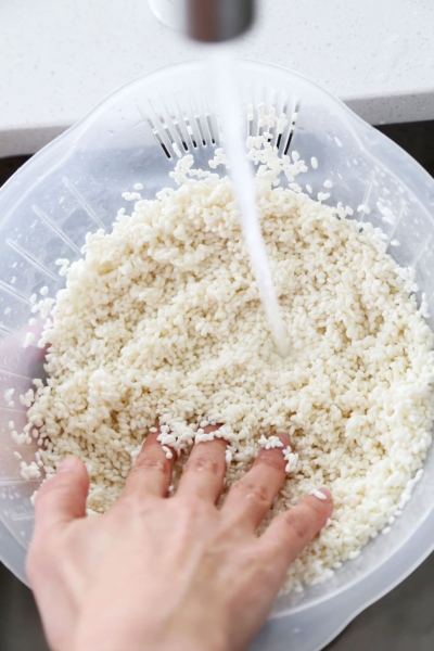 Washing sjort grain Japanese rice in a rice rinsing bowl