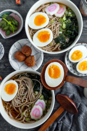 hot soba soup with fish cakes, eggs and pickled plum - toshikoshi soba