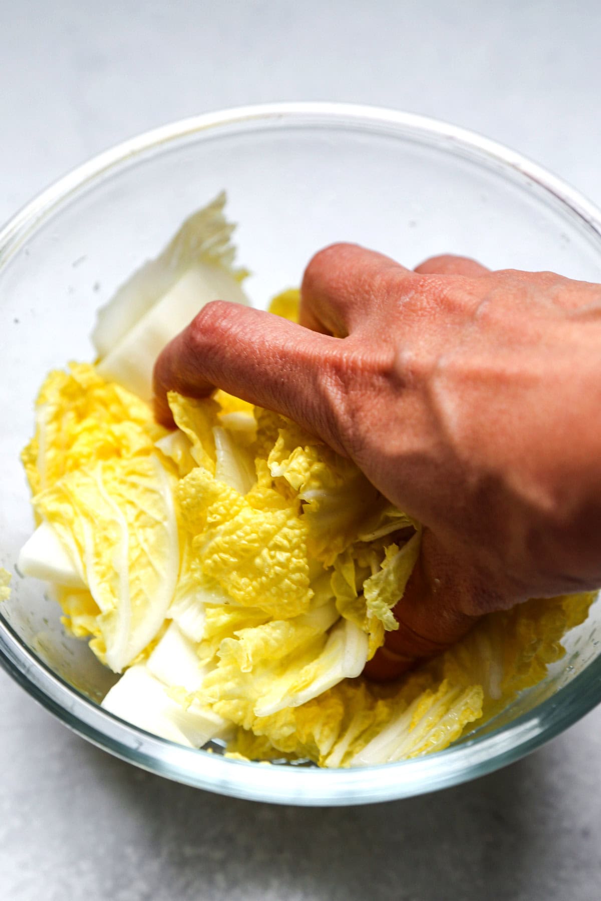 massaging cabbage leaves