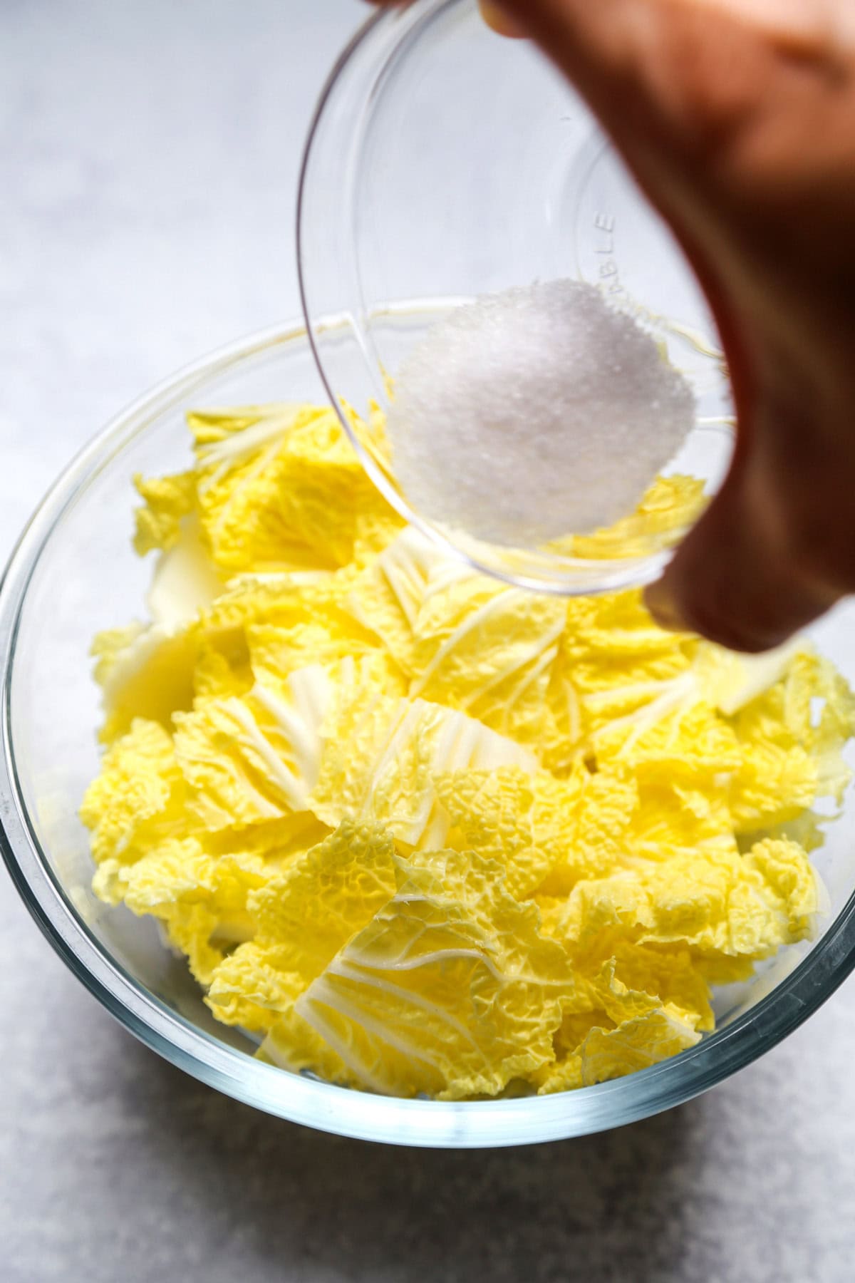 mixing salt with cabbage leaves