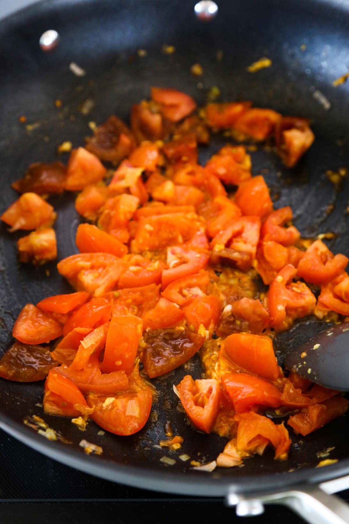 chopped tomatoes in skillet