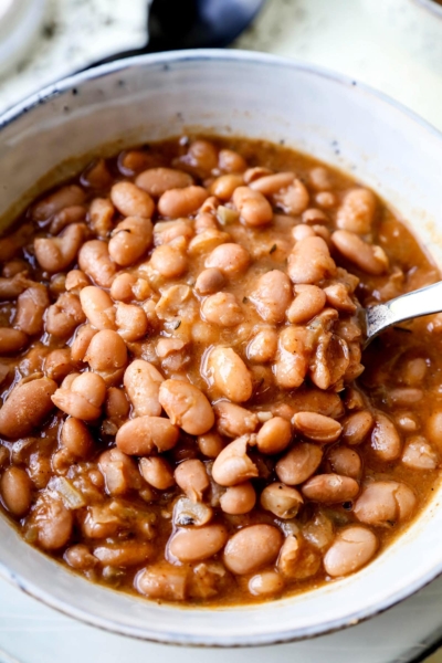 Slow Cooker Pinto Beans - The easiest, tastiest way to make beans! This is a healthy, easy vegetarian, vegan and gluten free pinto beans recipe using chili powder, and a medley of dried spices. Simple cooking that your entire family will love! #comfortfoods #vegetarian #vegan #glutenfree #slowcookerrecipes | pickledplum.com